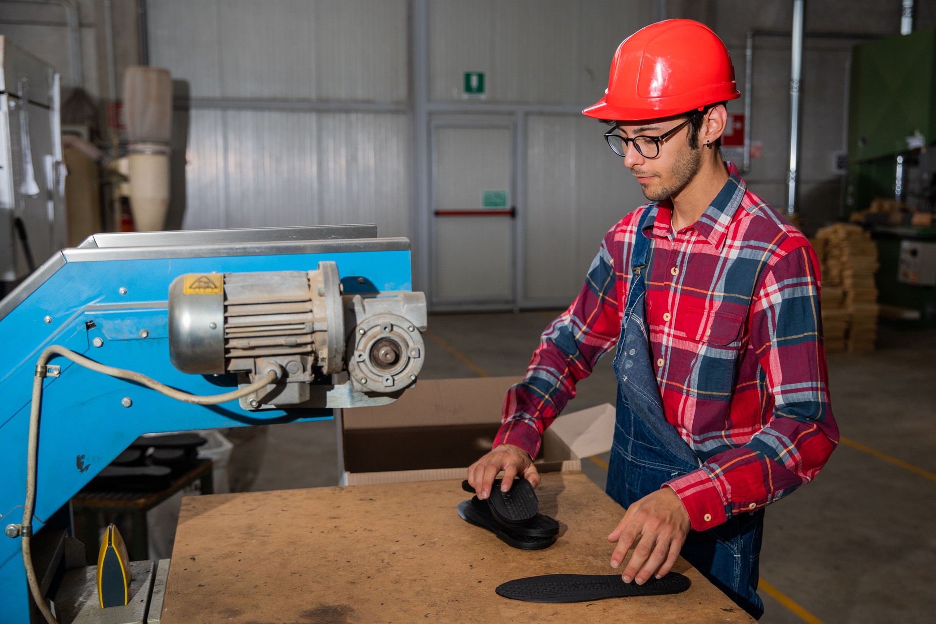 A specialized factory worker packs shoe soles, working life in the factory.
